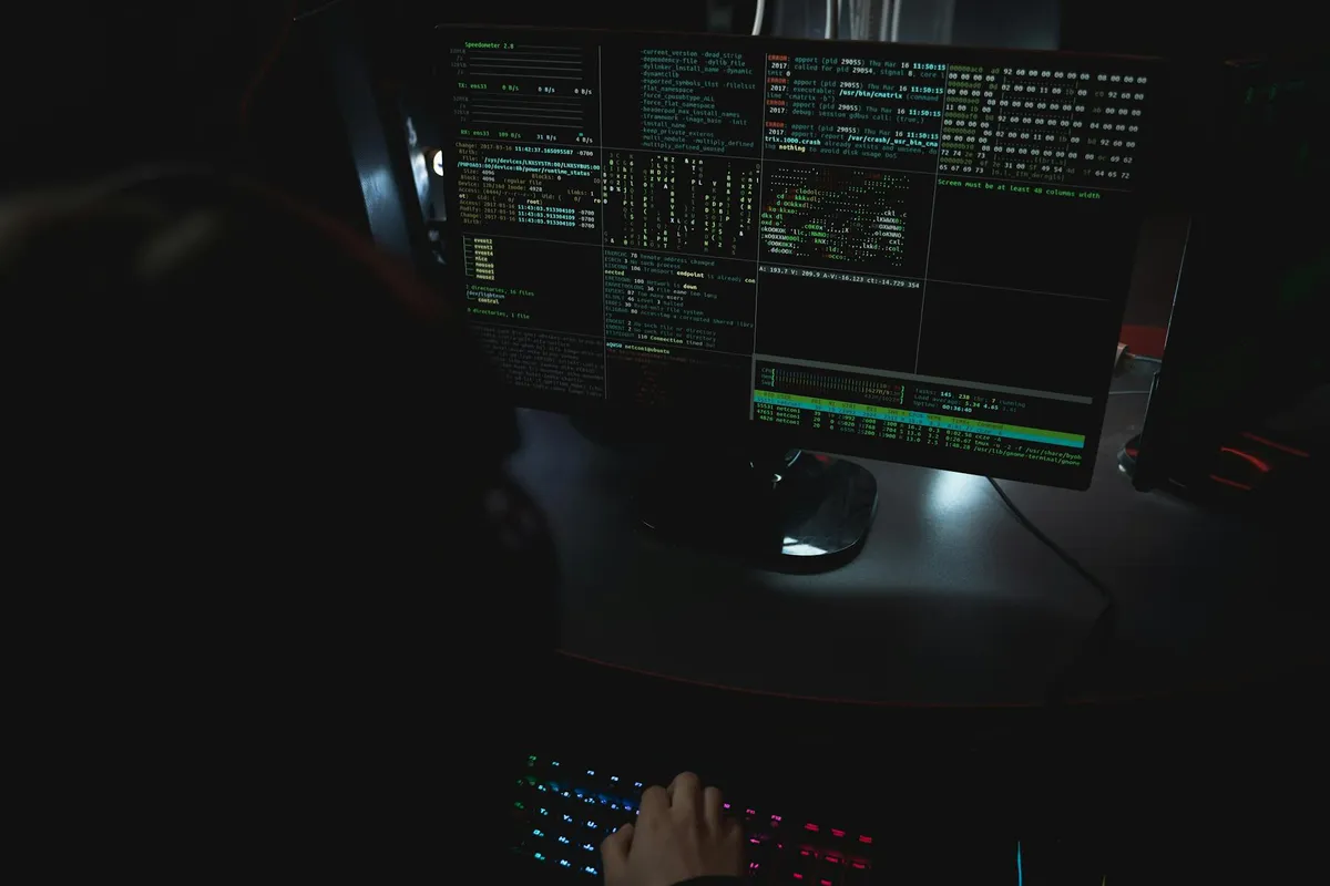 A laptop displaying router admin settings in a darkened home office